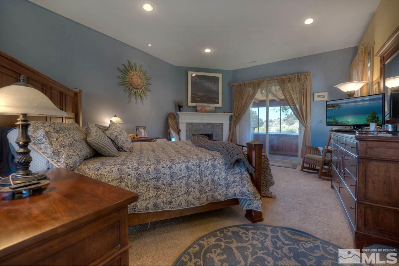 1215 Goldstone Road Reno, NV 89508 - Photo 12 of 23 a bedroom with furniture and a flat screen tv