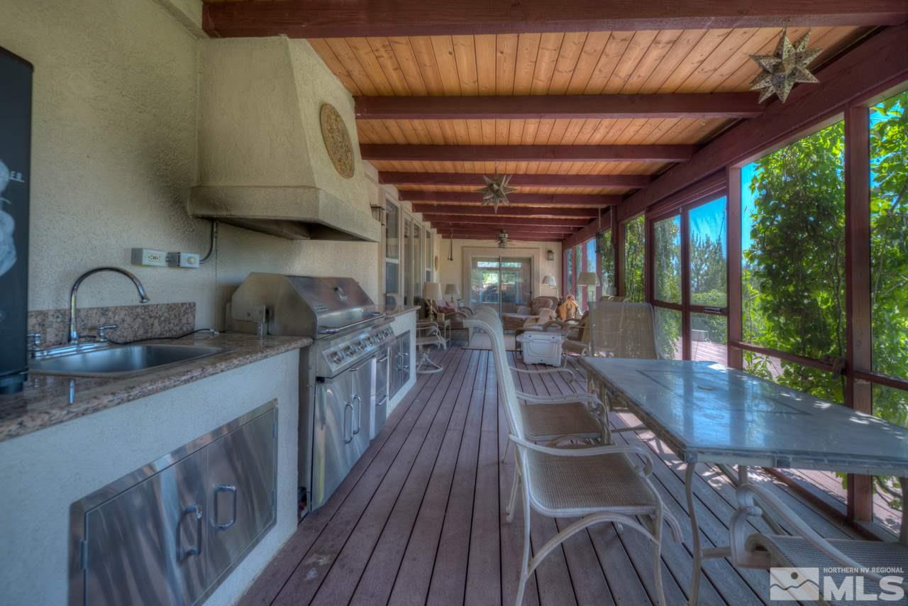 1215 Goldstone Road Reno, NV 89508 - Photo 19 of 23 a kitchen with wooden floors a sink and a view of living room