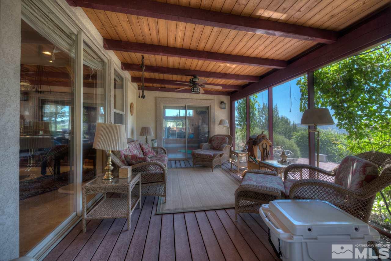 1215 Goldstone Road Reno, NV 89508 - Photo 20 of 23 a view of a patio with chairs and potted plants with wooden floor
