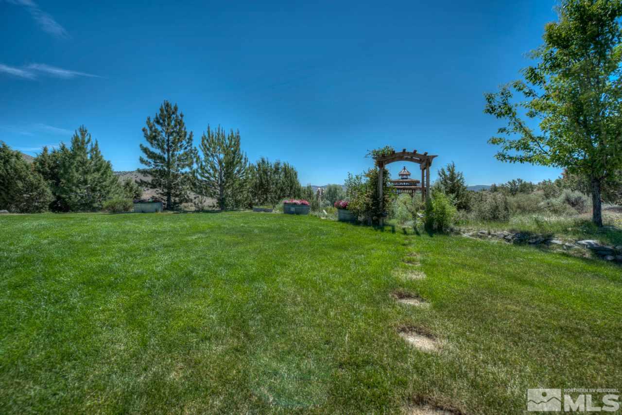 1215 Goldstone Road Reno, NV 89508 - Photo 23 of 23 a view of a green field with trees in the background
