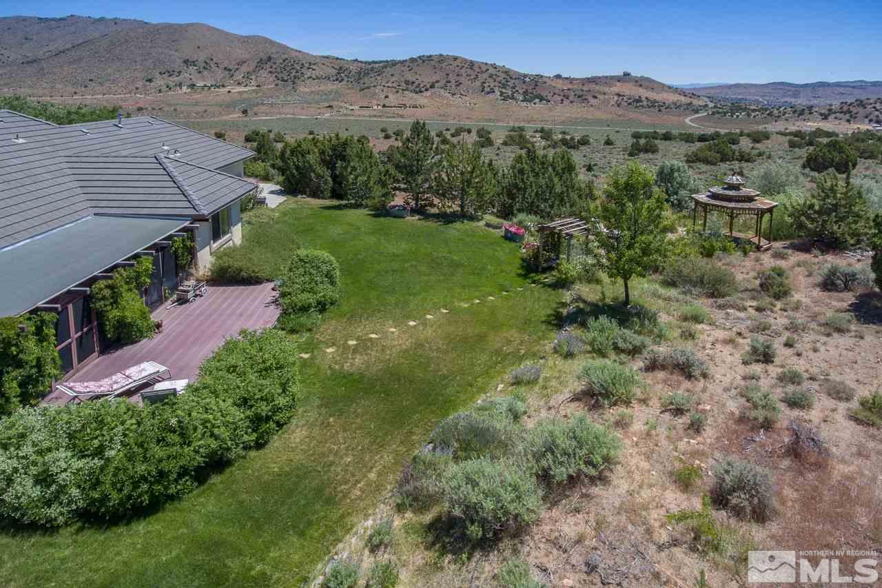 1215 Goldstone Road Reno, NV 89508 - Photo 4 of 23 a view of a lush green hillside and a houses