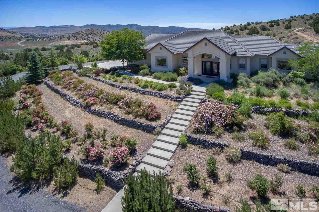 1215 Goldstone Road Reno, NV 89508 - Photo 5 of 23 a view of a house with a yard and a large tree