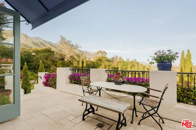 a view of a chairs and table in patio