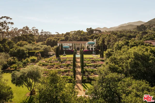 a view of residential houses with outdoor space and trees