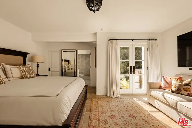 a bedroom with a bed and a couch