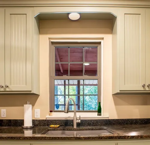 a bedroom with a bed lamp and a window