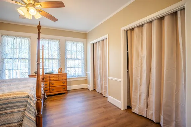 a bedroom with a bed and a large window with outer view