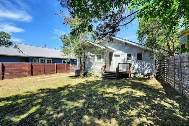 a view of a house with backyard porch and sitting area