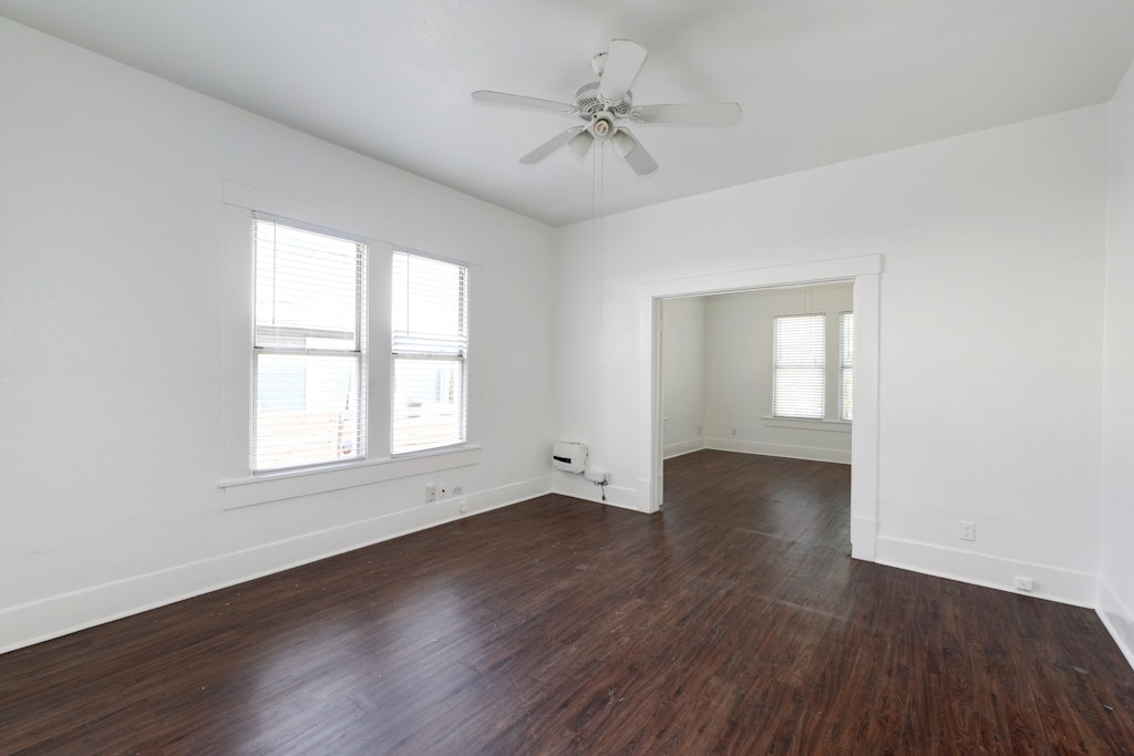 1205 East 12th Street Austin, TX 78702 - Photo 5 of 15 an empty room with wooden floor and windows