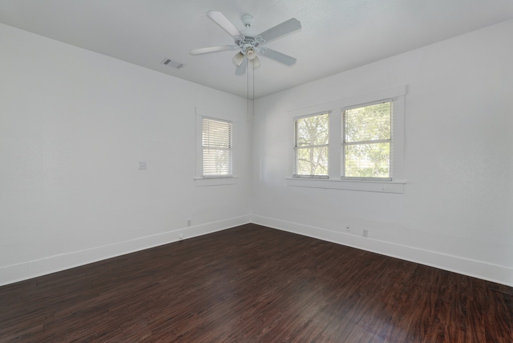 1205 East 12th Street Austin, TX 78702 - Photo 10 of 15 an empty room with wooden floor and windows
