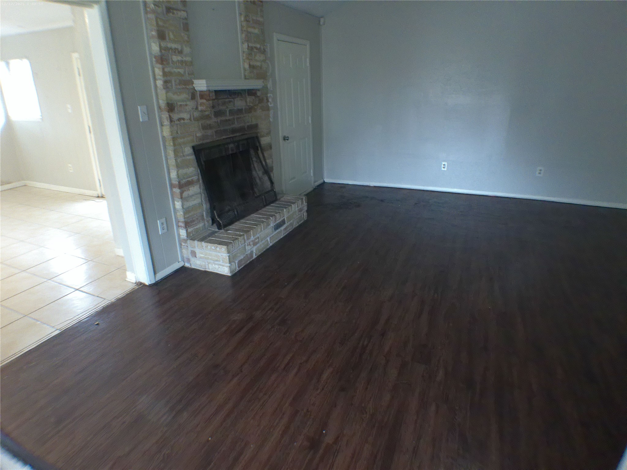 7322 West Fuqua Street Houston, TX 77489 - Photo 11 of 18 a view of a livingroom with wooden floor and a fireplace