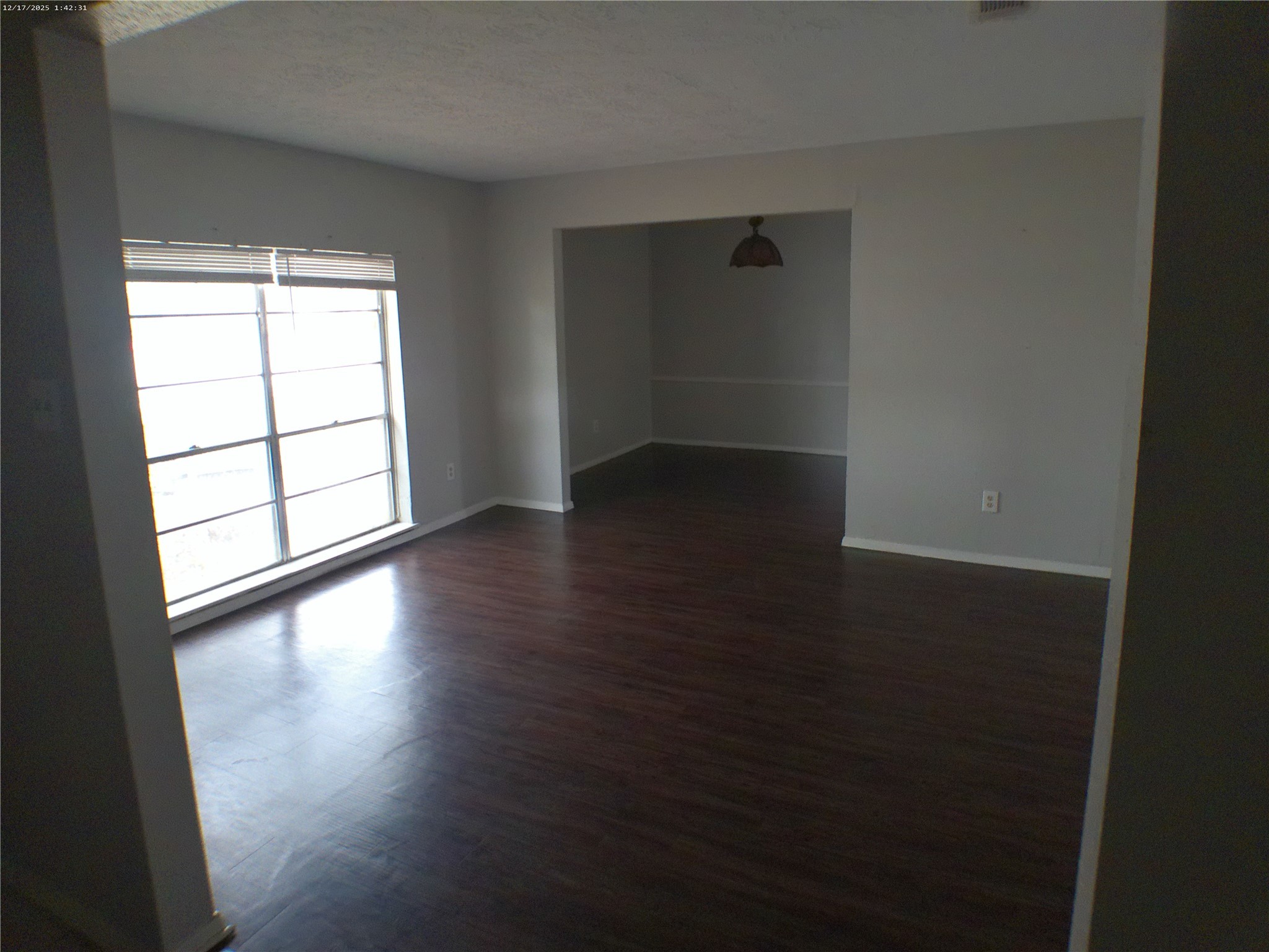 7322 West Fuqua Street Houston, TX 77489 - Photo 13 of 18 an empty room with wooden floor and windows