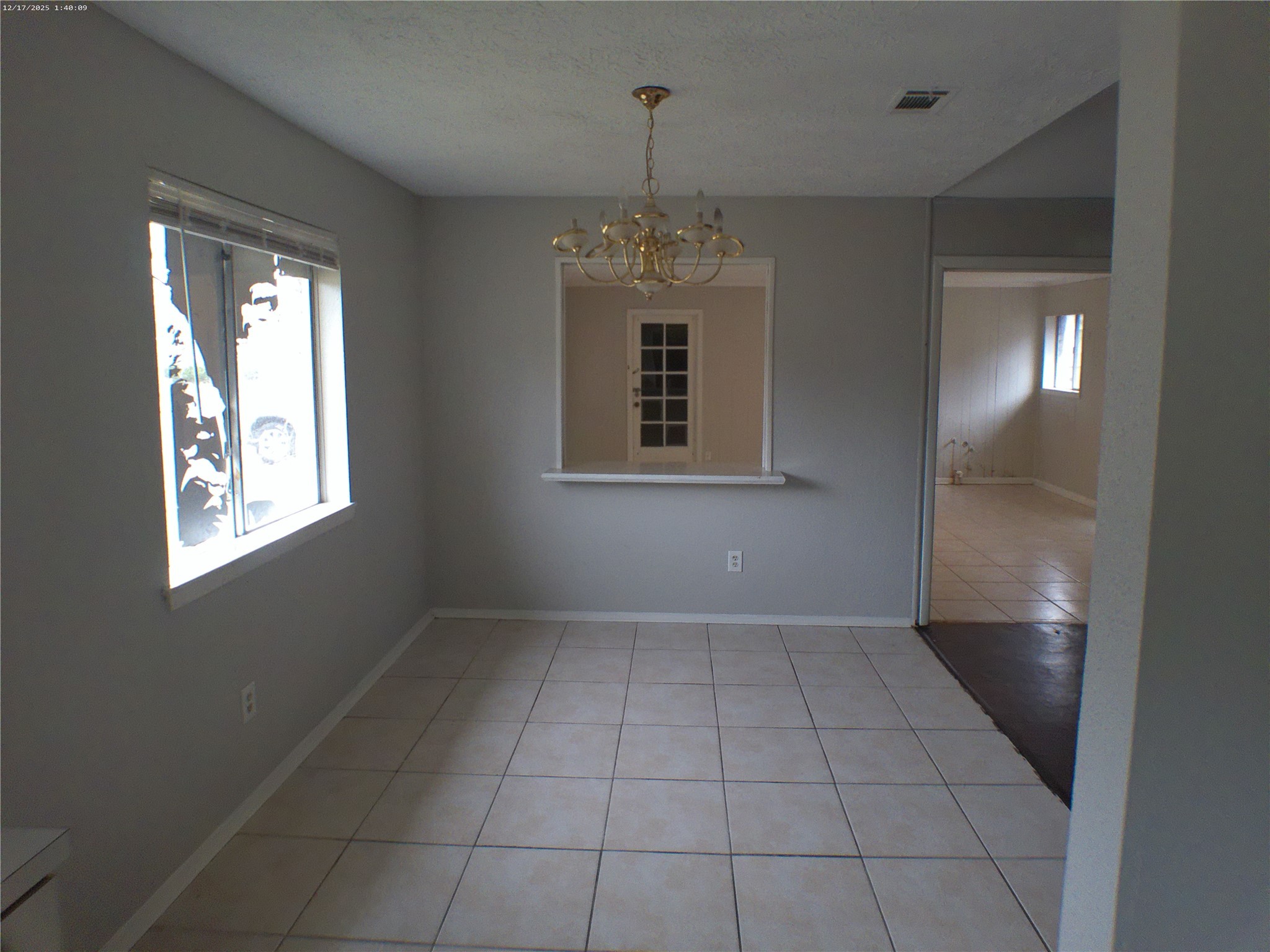7322 West Fuqua Street Houston, TX 77489 - Photo 7 of 18 an empty room with chandelier fan and windows
