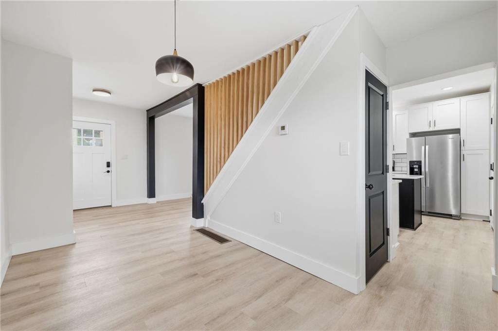 2961 Ruthwood Avenue Pittsburgh, PA 15227 - Photo 10 of 29 a view of a hallway with wooden floor and a kitchen
