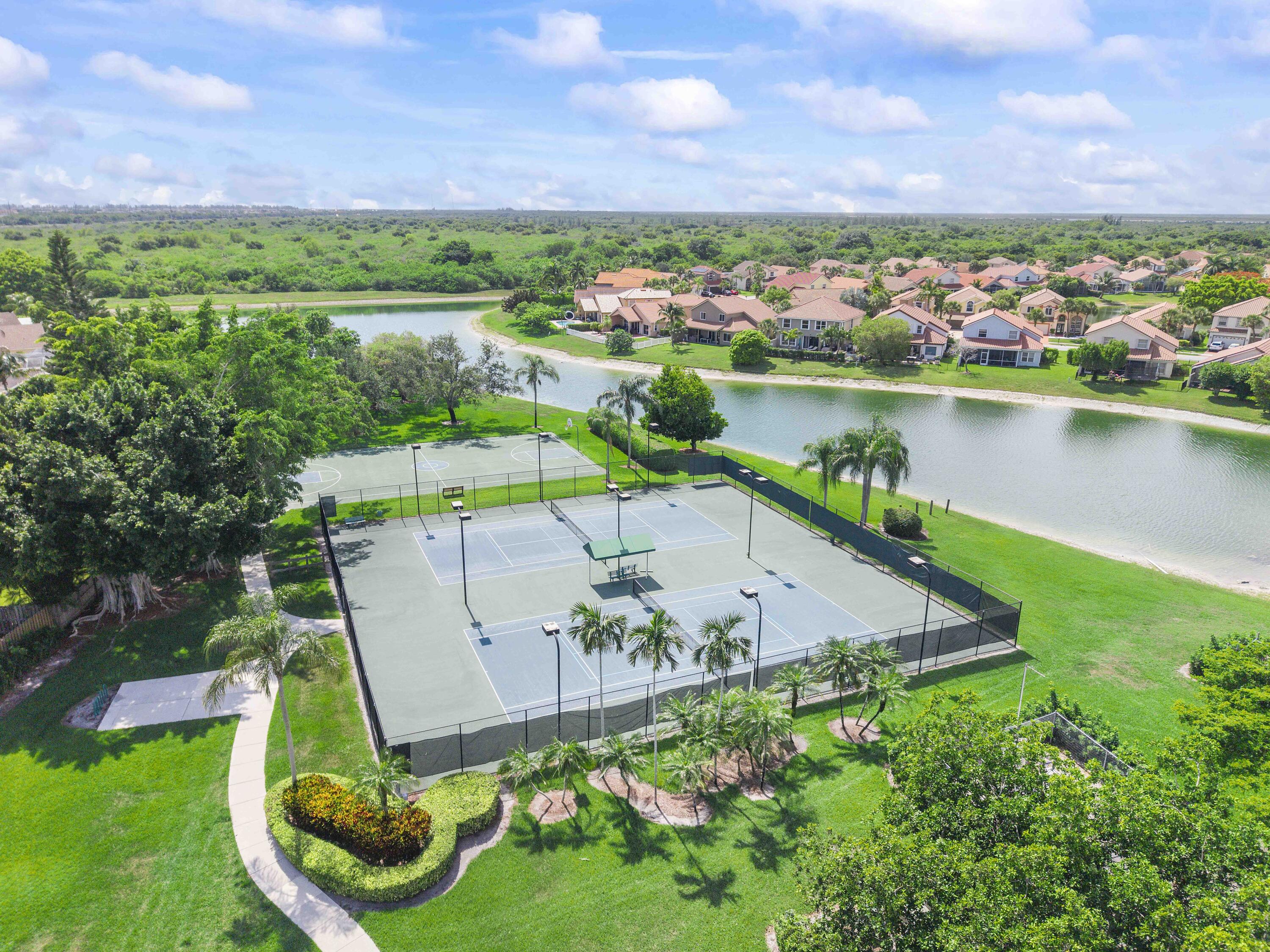 12328 St Simon Drive Boca Raton, FL 33428 - Photo 50 of 52 an aerial view of a house with a garden and lake view