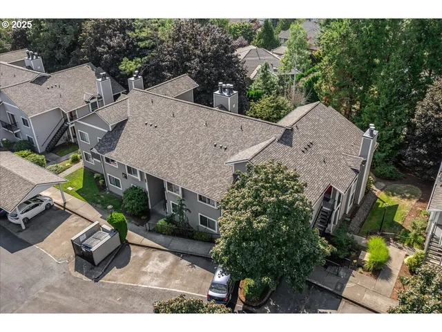 an aerial view of a house with garden space and street view