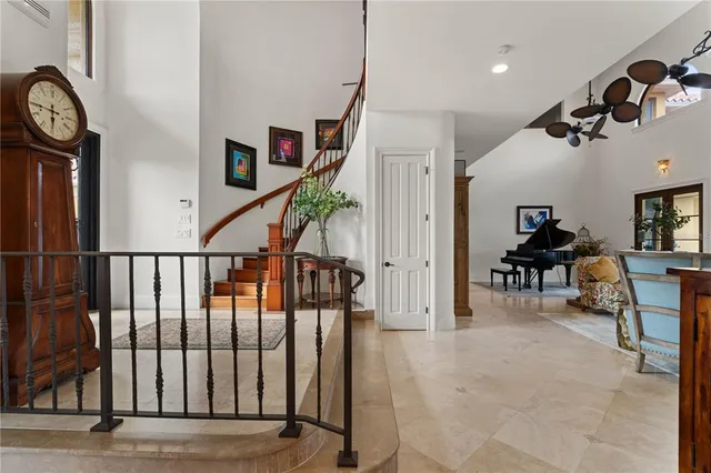 a bed sitting in a spacious bedroom next to a window