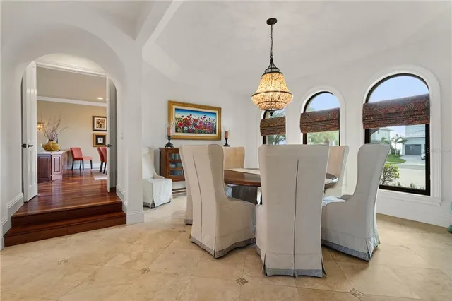 a view of a chair and tables in the patio in front of a house