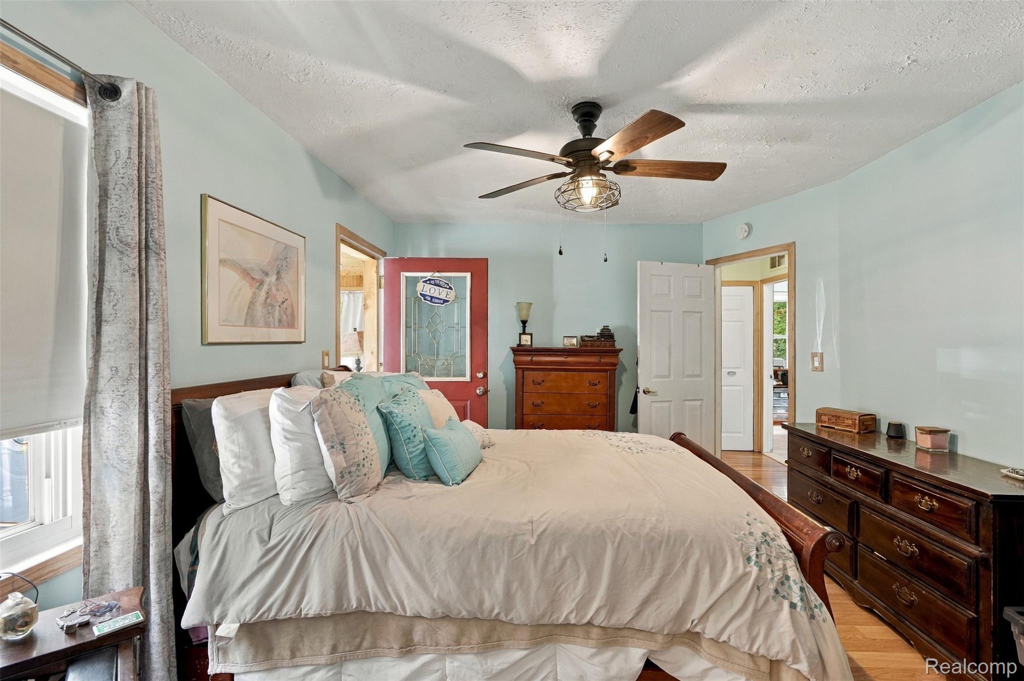 36739 Wick Road Romulus, MI 48174 - Photo 15 of 56 Vaulted ceiling with a ceiling fan, hardwood flooring, and light blue walls