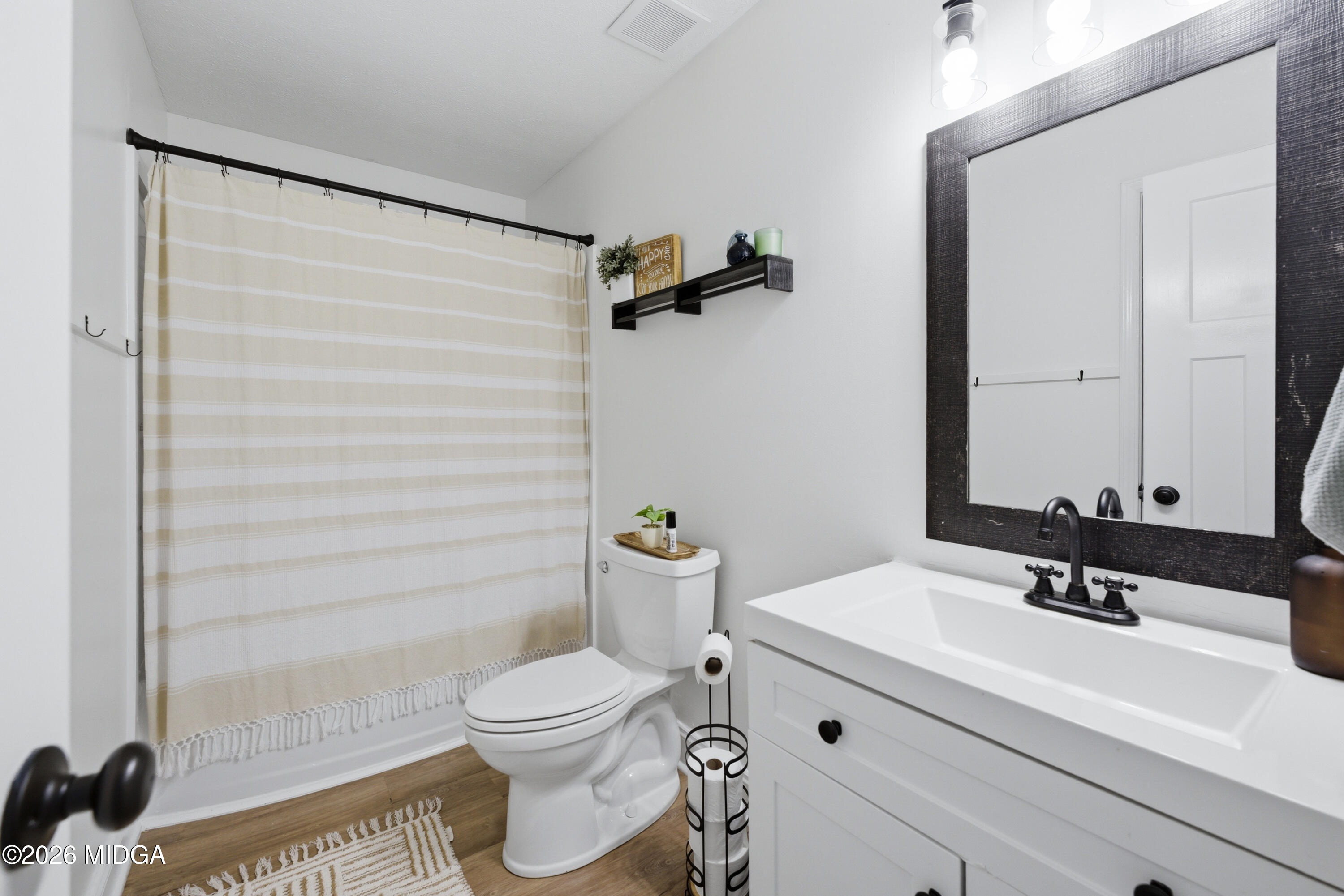 123 Mathews Road Milner, GA 30257 - Photo 24 of 51 a bathroom with a sink a toilet and shower