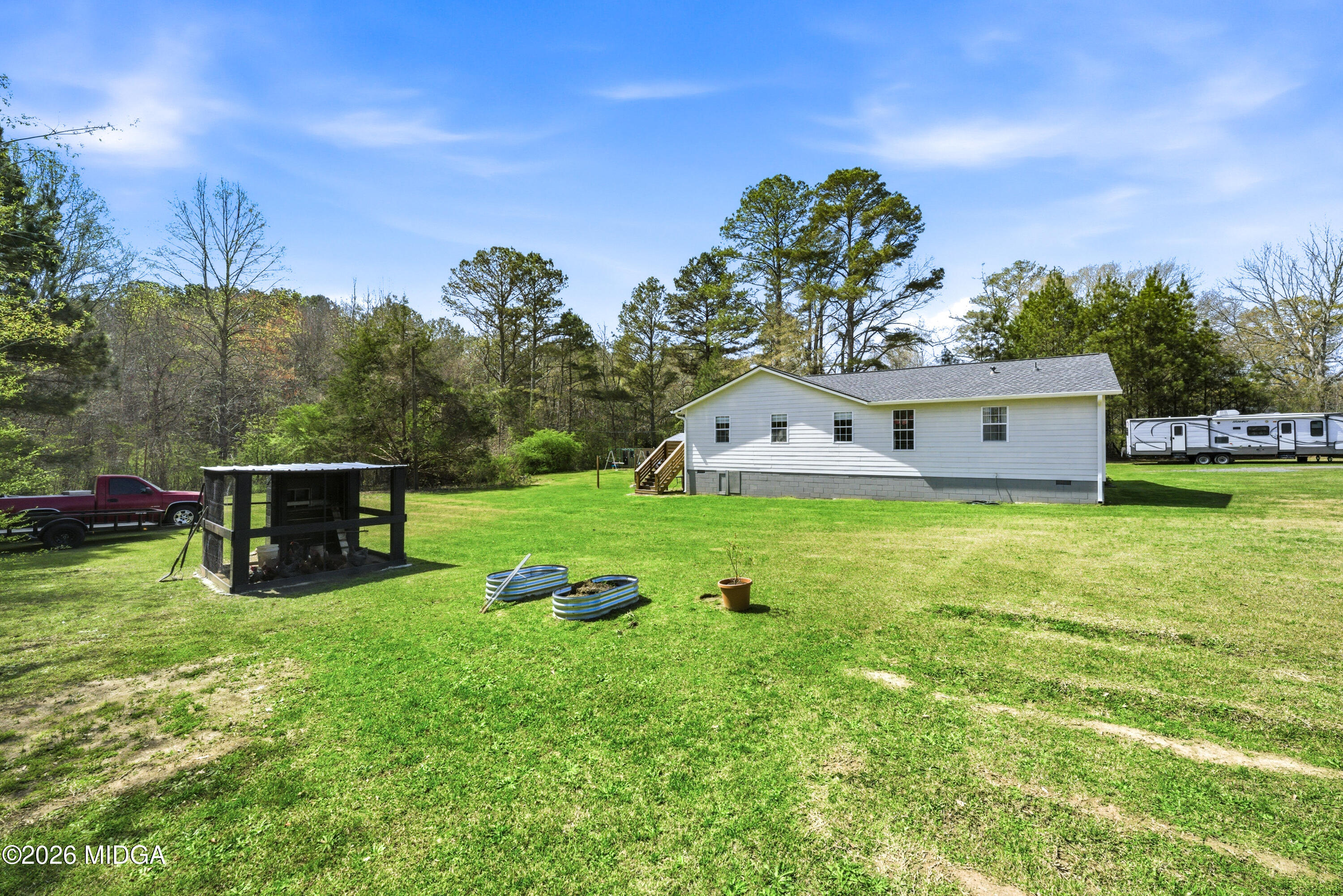 123 Mathews Road Milner, GA 30257 - Photo 43 of 51 a view of a house with a yard balcony and sitting area