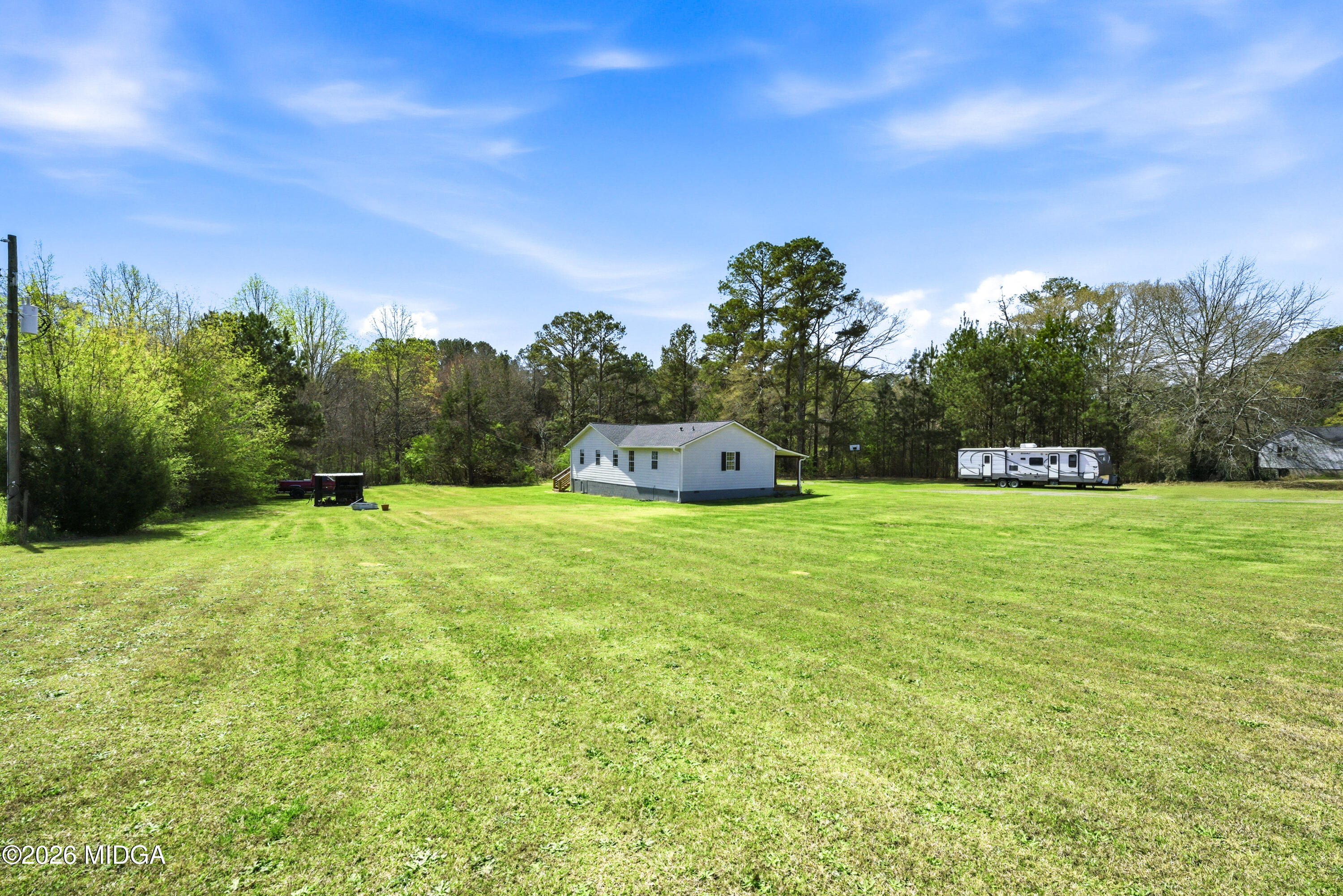 123 Mathews Road Milner, GA 30257 - Photo 44 of 51 a green field with lots of trees in the background