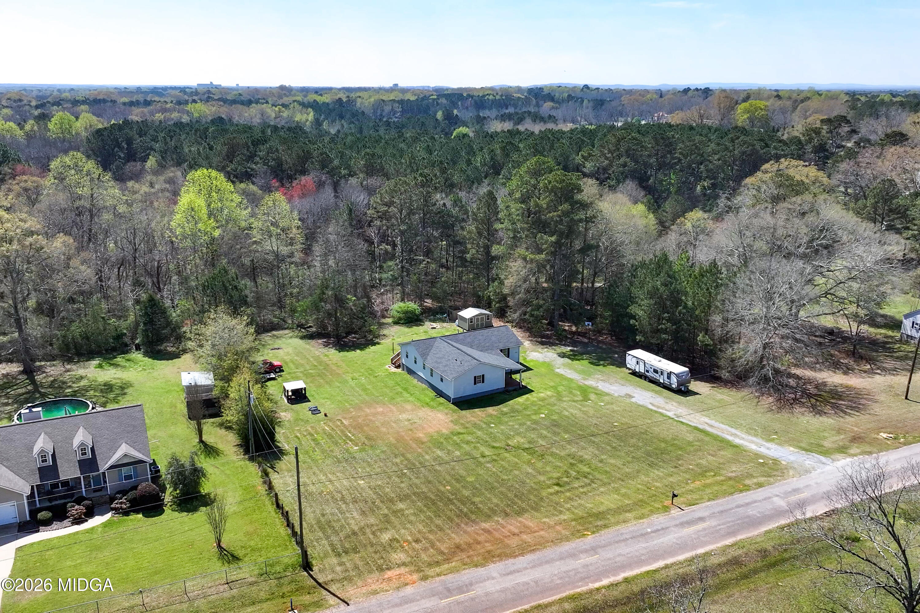 123 Mathews Road Milner, GA 30257 - Photo 50 of 51 a view of a small house with a yard