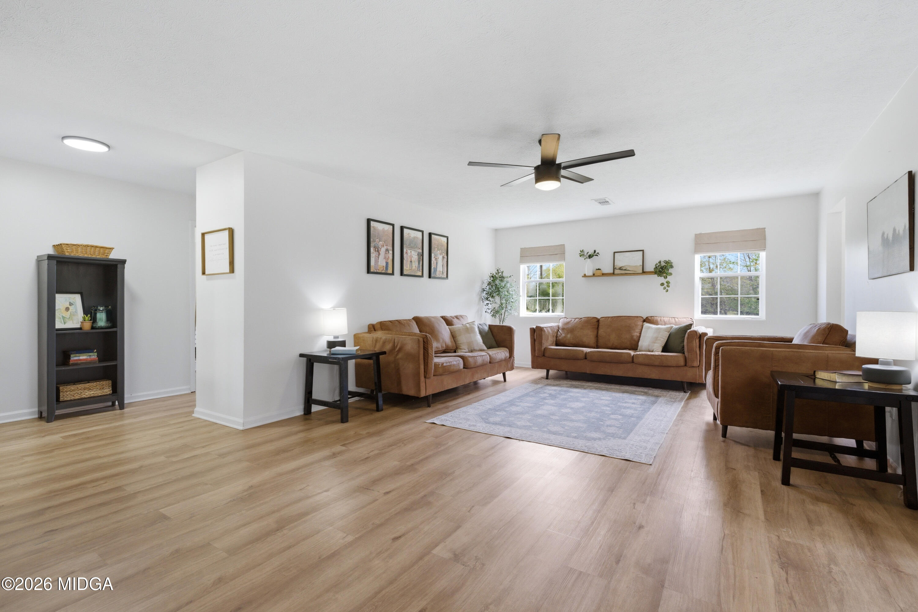 123 Mathews Road Milner, GA 30257 - Photo 6 of 51 a living room with furniture and a wooden floor