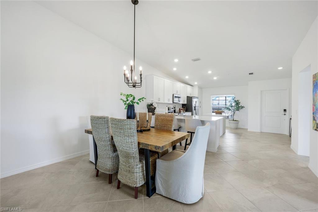 5454 Double Eagle Circle, Unit 3321 Immokalee, FL 34142 - Photo 11 of 40 a dining room with furniture and a chandelier