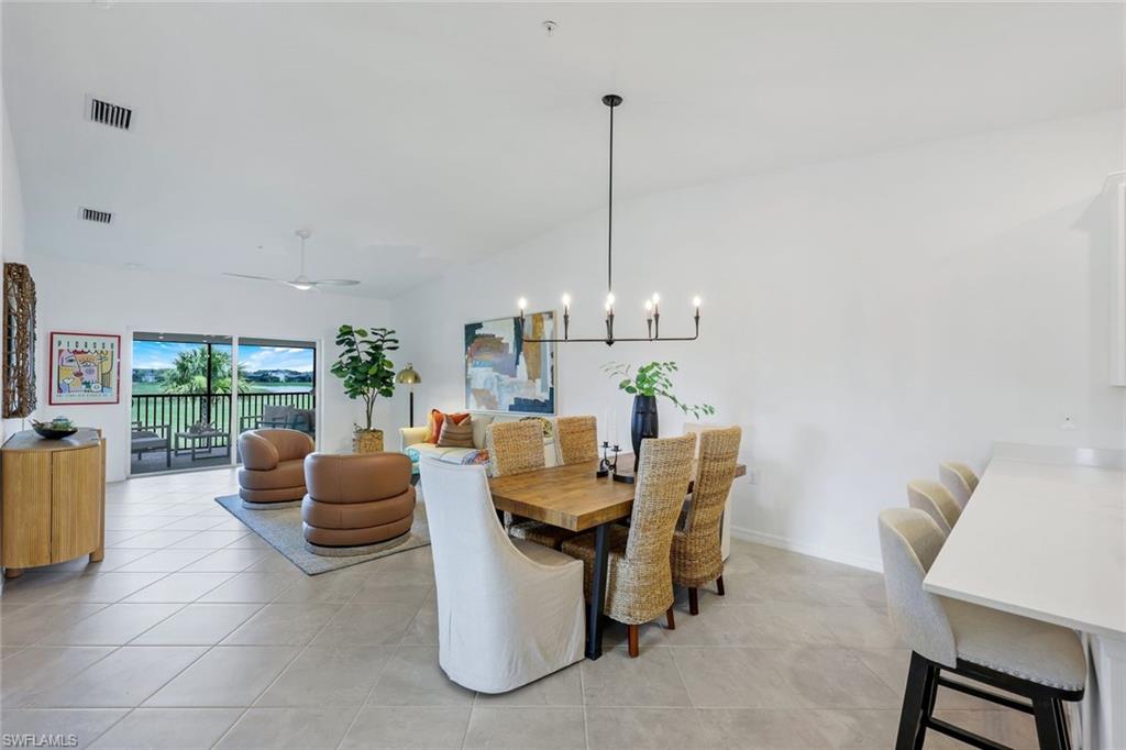 5454 Double Eagle Circle, Unit 3321 Immokalee, FL 34142 - Photo 12 of 40 a dining room with furniture a chandelier and a rug