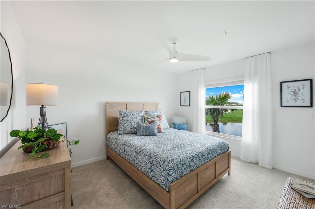 5454 Double Eagle Circle, Unit 3321 Immokalee, FL 34142 - Photo 17 of 40 a bedroom with a large bed and a potted plant