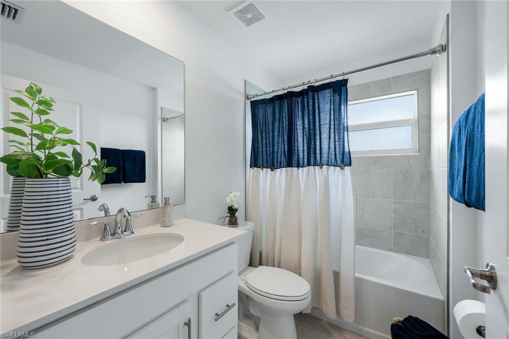 5454 Double Eagle Circle, Unit 3321 Immokalee, FL 34142 - Photo 18 of 40 a bathroom with a sink toilet and shower