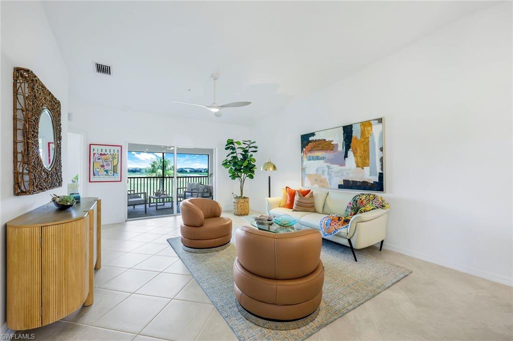 5454 Double Eagle Circle, Unit 3321 Immokalee, FL 34142 - Photo 5 of 40 a living room with furniture and a large window