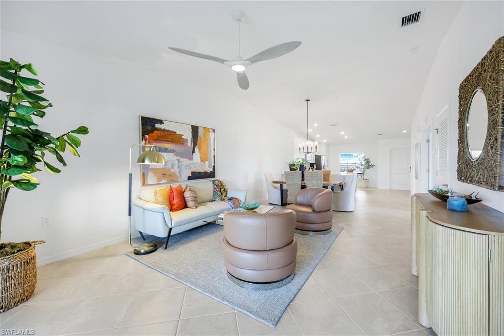 5454 Double Eagle Circle, Unit 3321 Immokalee, FL 34142 - Photo 7 of 40 a living room with furniture and a potted plant