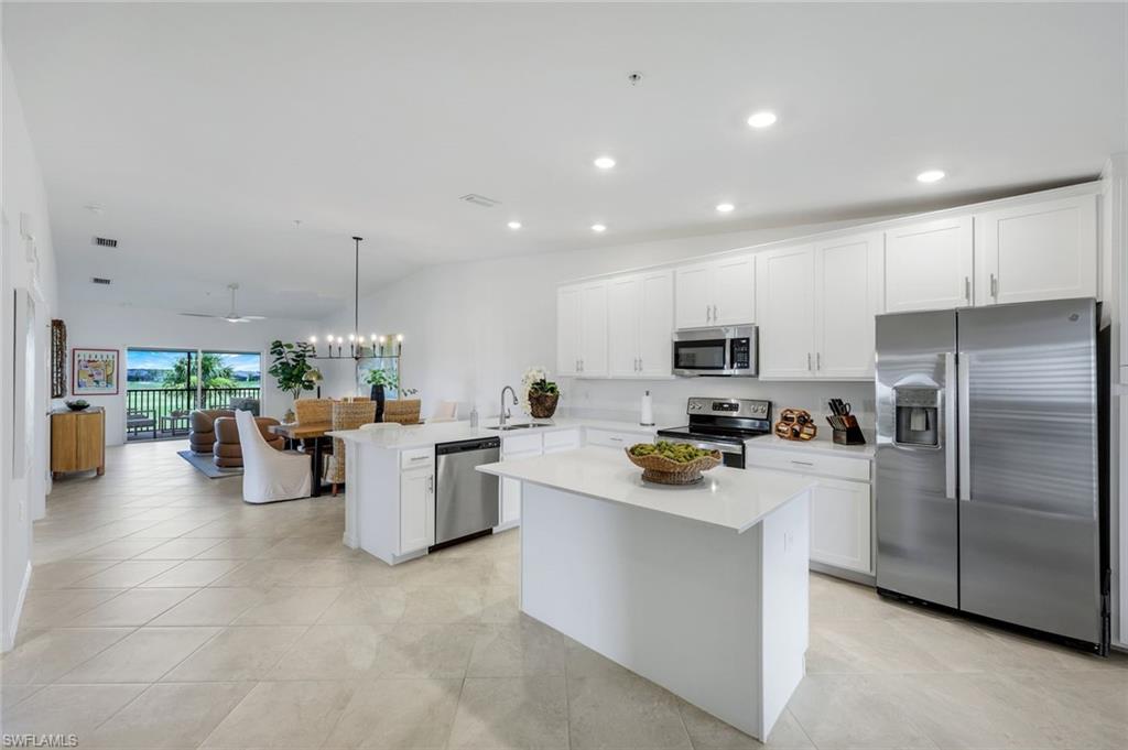 5454 Double Eagle Circle, Unit 3321 Immokalee, FL 34142 - Photo 40 of 40 a kitchen with a sink a counter top stainless steel appliances and cabinets