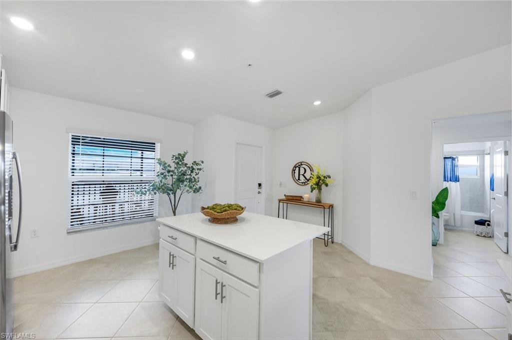 5454 Double Eagle Circle, Unit 3321 Immokalee, FL 34142 - Photo 8 of 40 a view of kitchen center island and living room
