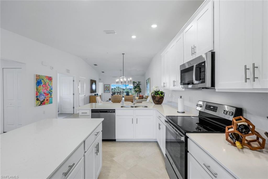 5454 Double Eagle Circle, Unit 3321 Immokalee, FL 34142 - Photo 9 of 40 a kitchen with a sink a stove and cabinets