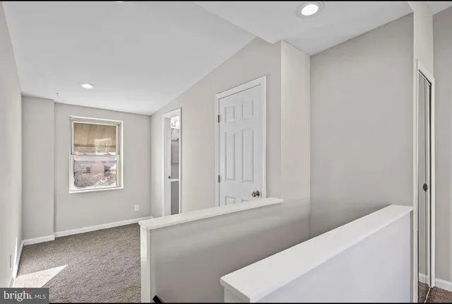 an empty room with windows and closet