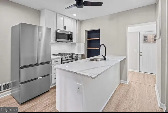 a kitchen with stainless steel appliances a refrigerator stove and microwave