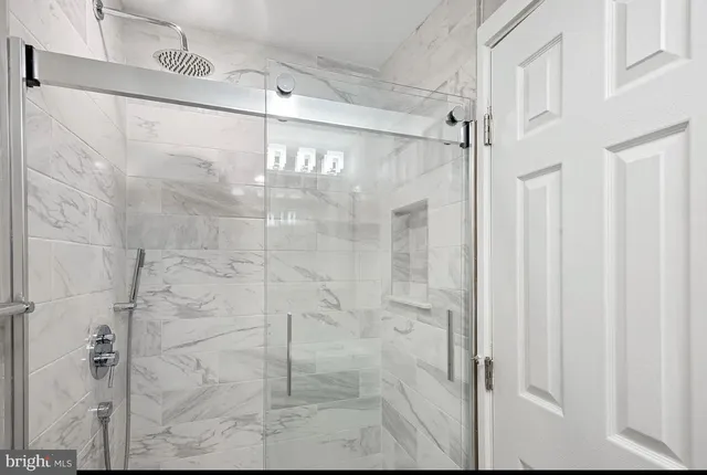 a bathroom with a glass shower door