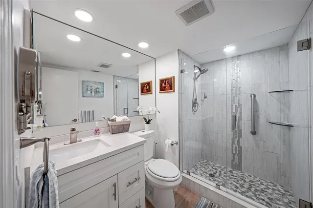 a bathroom with a sink toilet and shower
