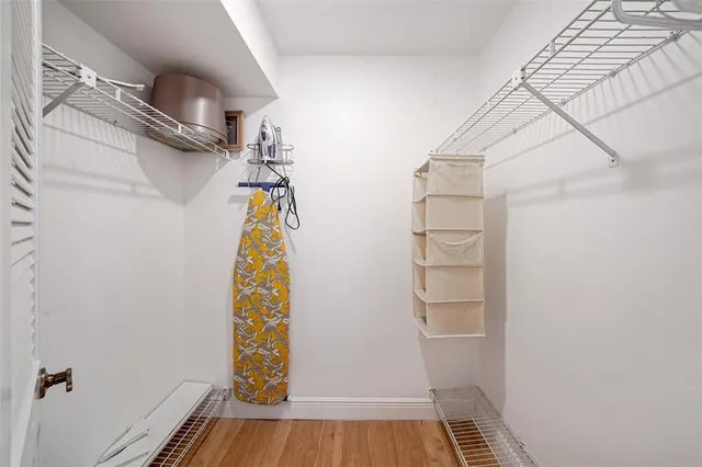 a view of walk in closet with empty racks