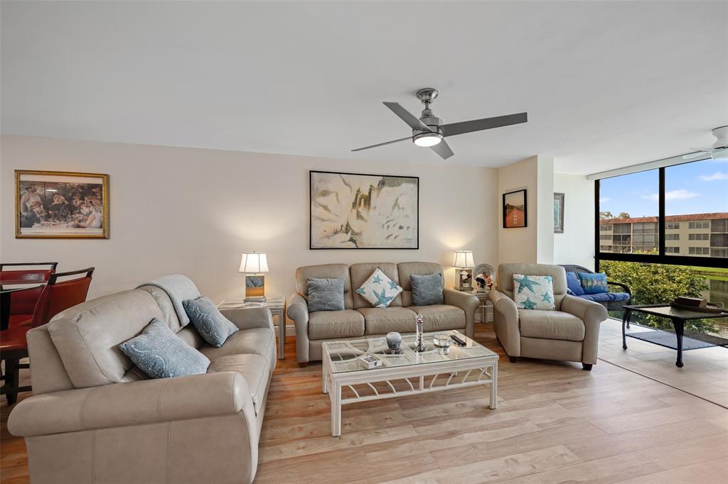 361 South Hollybrook Drive, Unit 201 Pembroke Pines, FL 33025 - Photo 19 of 52 a living room with furniture ceiling fan and a large window