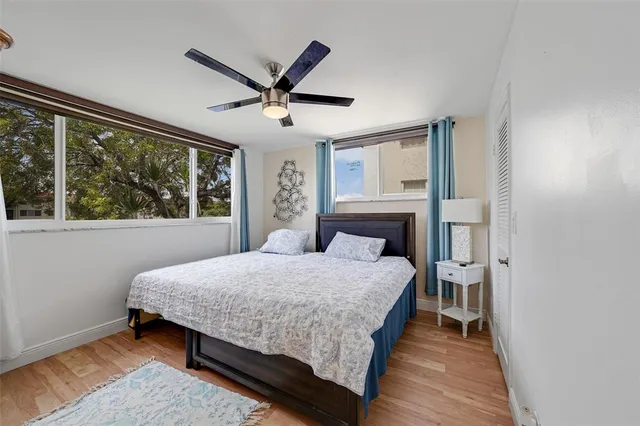 a bedroom with a large bed and a large window