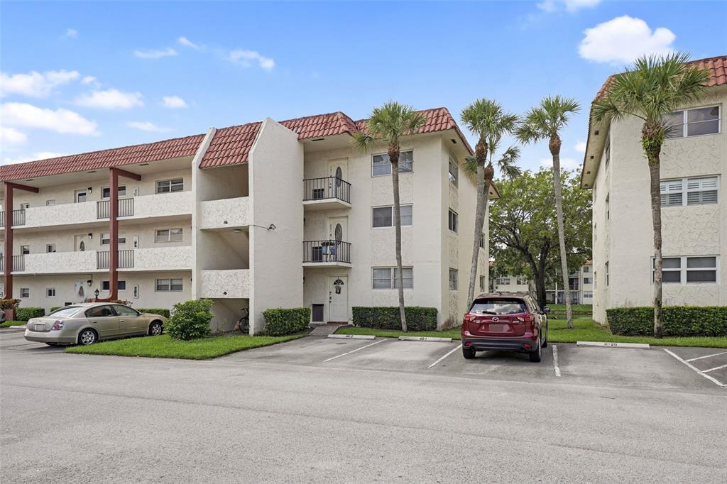 361 South Hollybrook Drive, Unit 201 Pembroke Pines, FL 33025 - Photo 31 of 52 a car parked in front of a building