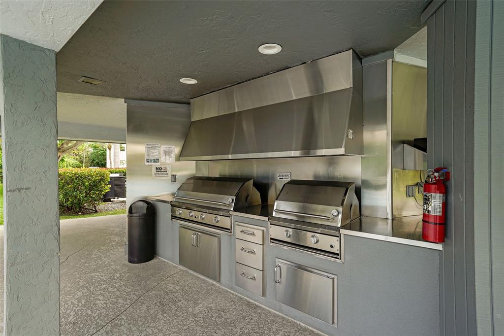 361 South Hollybrook Drive, Unit 201 Pembroke Pines, FL 33025 - Photo 33 of 52 a kitchen with stainless steel appliances granite countertop a stove and a refrigerator