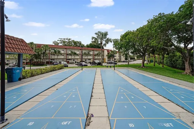 a view of a patio with table and chairs under an umbrella