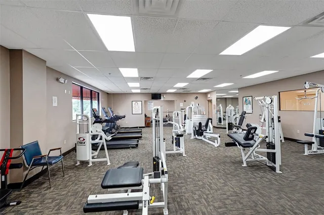 a room with gym equipment and windows