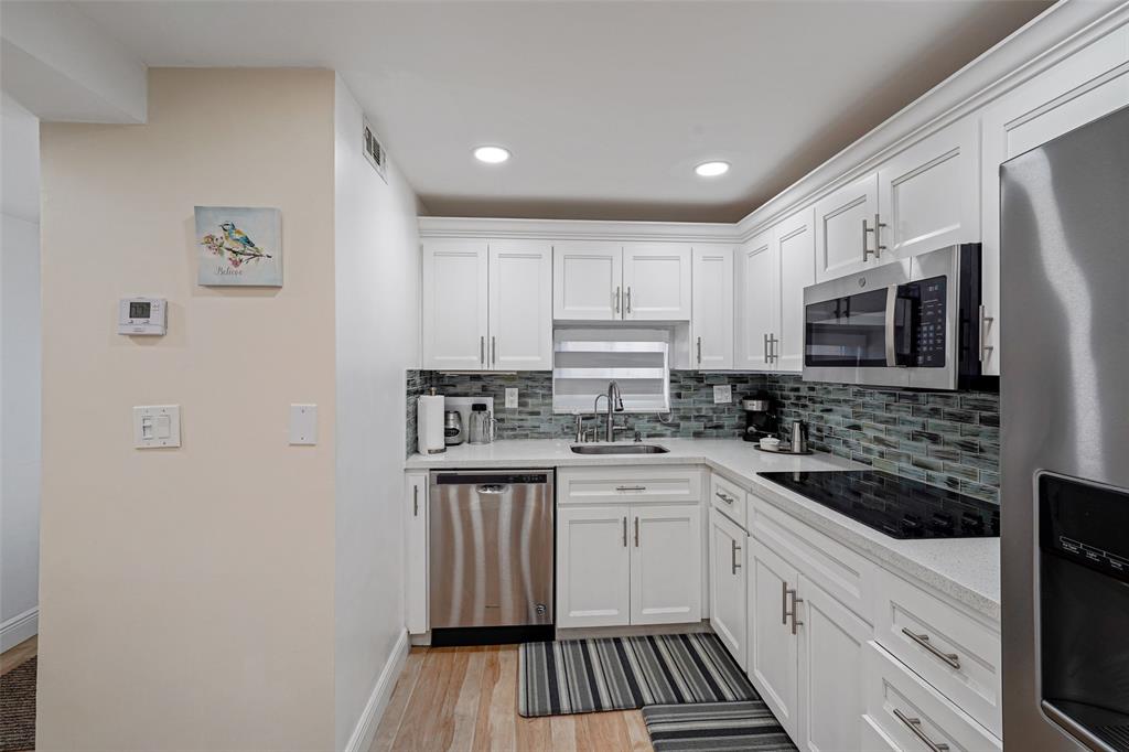 361 South Hollybrook Drive, Unit 201 Pembroke Pines, FL 33025 - Photo 5 of 52 a kitchen with stainless steel appliances a sink stove microwave and cabinets