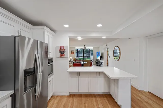 a kitchen with stainless steel appliances a refrigerator and a stove